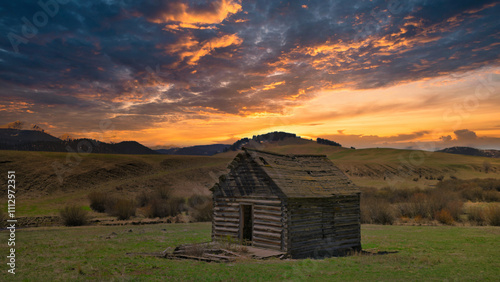 Photography old rundown cabin at sunset in montana mountains