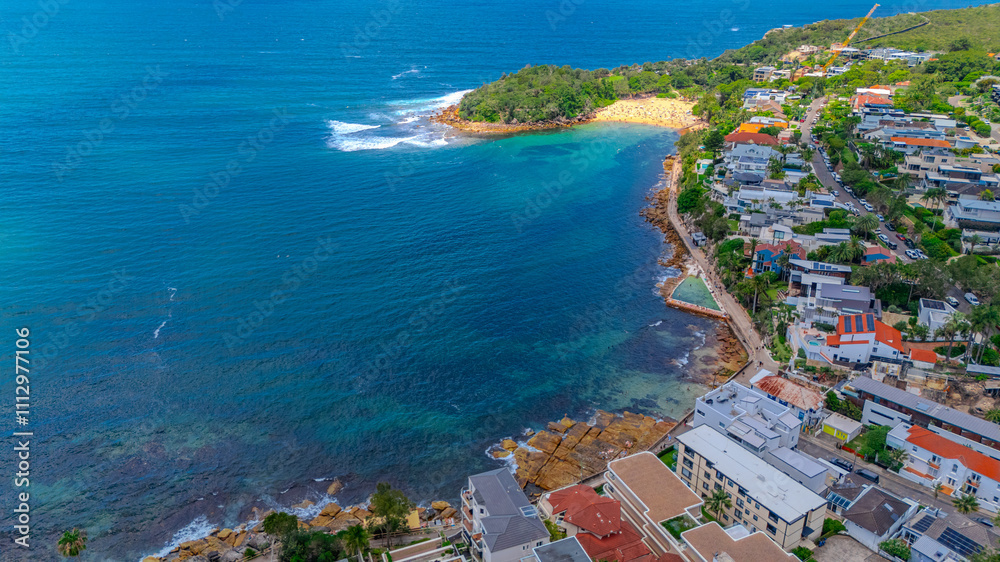Naklejka premium Aerial View of Manly Beach and Sydney harbour with manly houses on a warm summer day blue skies Sydney NSW Australia