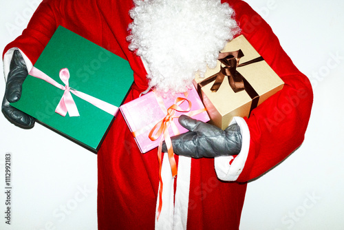 Santa Claus with white beard holding Christmas presents and flashlight