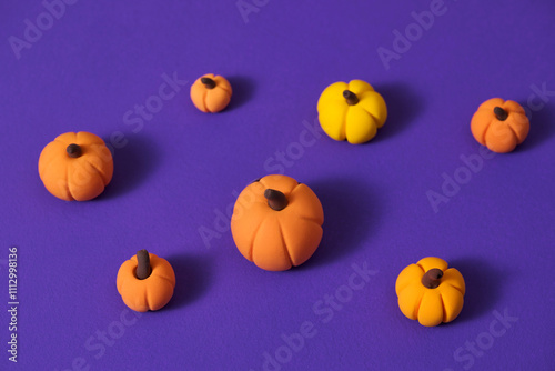 Colorful Miniature Pumpkins on Vibrant Purple Background photo