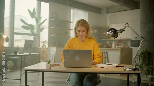 Attractive business woman opens and typing on laptop in office. Busy work day. Camera moving around. 360 degrees