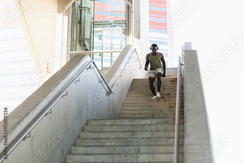 Sporty Man Running Up Stairs in Modern City Environment photo