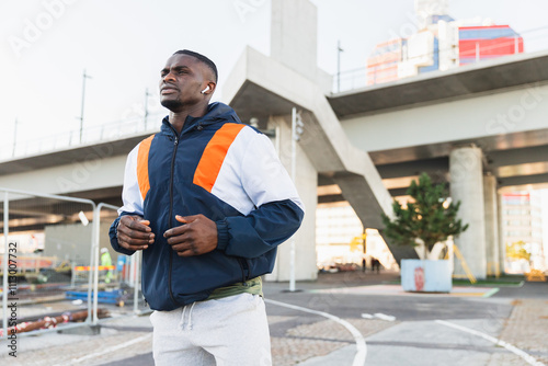 Sporty Man Running on Sidewalk in Urban City photo