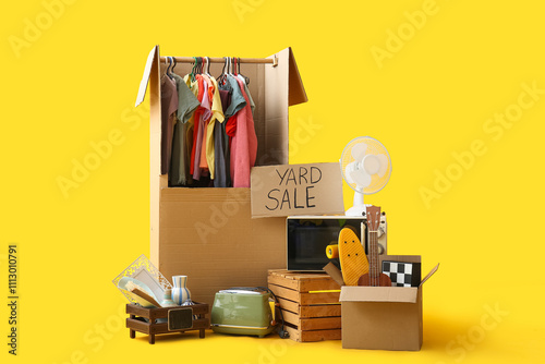 Fotografía Unwanted stuff for yard sale on yellow background