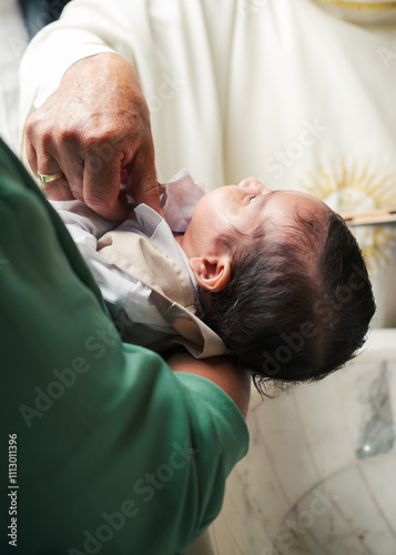 Baby receiving blessings at her christening