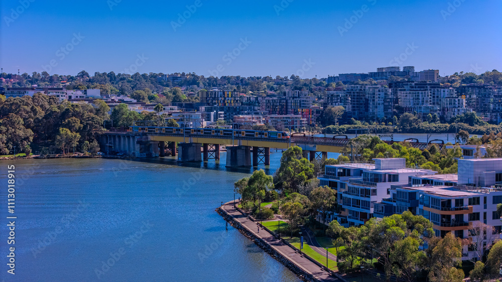 Fototapeta premium Panorama Aerial view above Rhodes with views to Meadowbank and Olympic park and Wentworth Point and Concord West with Parramatta River in Sydney NSW Australia
