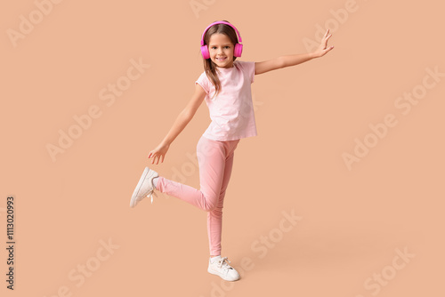 Happy little girl in headph...