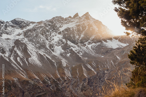 Sunlit mountain landscape with snowy peaks

 photo