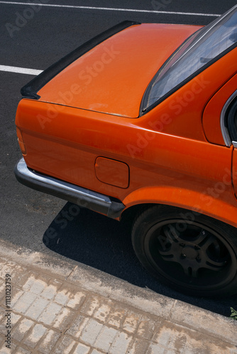 Orange Car Parked on Street photo