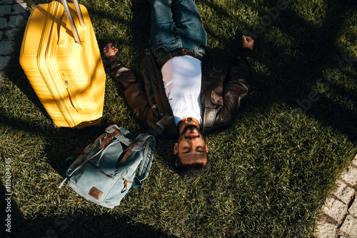 An Indian man having a rest on the grass while his travelling. photo