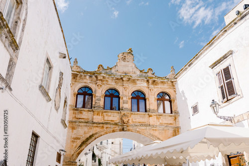 A rustic archway crossing a street of the town of Ostuni in Apulia