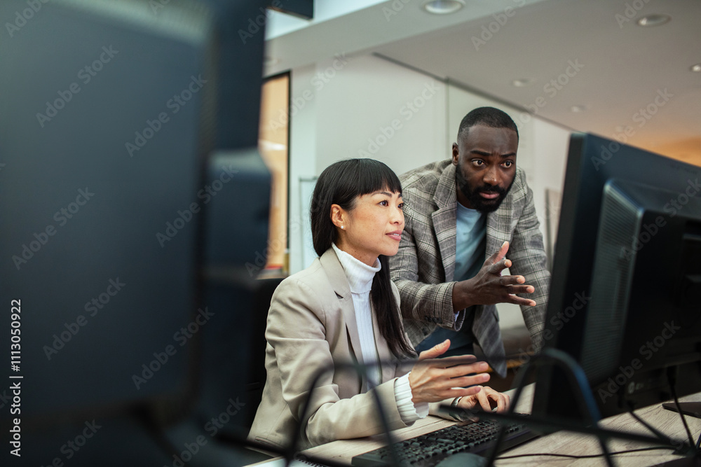 Diverse business people working together on office computer Diverse business people working together on office computer