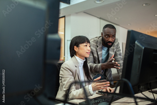 Diverse business people working together on office computer