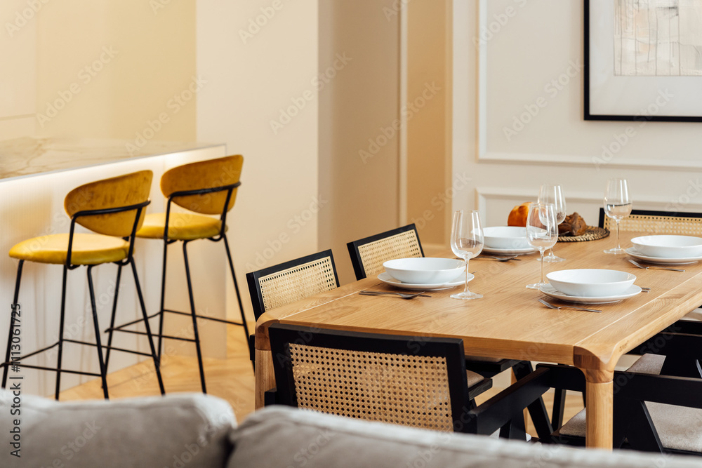 Elegant modern dining setup with wooden table and chairs Elegant modern dining setup with wooden table and chairs