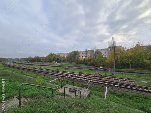 Bahngleise in Berlin Hellersdorf/Marzahn, mit atmosphärischem Wolkenhimmel photo