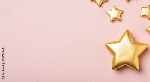 Golden stars on light pink background for decoration or celebration photo