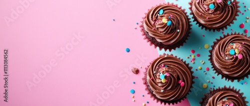 Delicious chocolate cupcakes with colorful sprinkles on a pastel background.