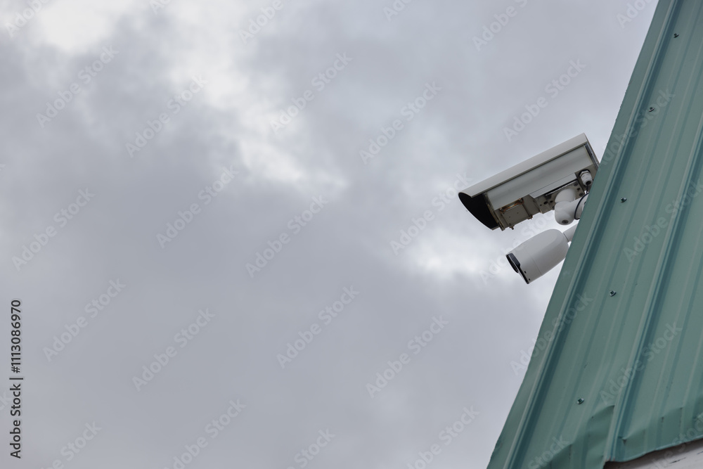 A smart security camera on a house roof A smart security camera on a house roof