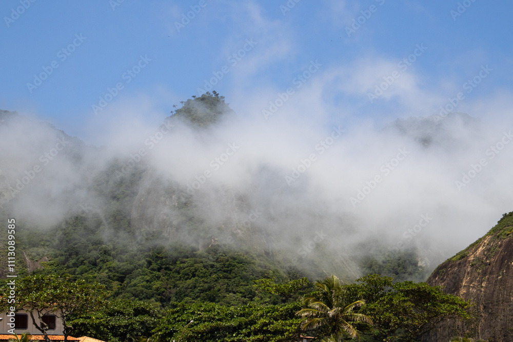 Fototapeta premium Low Clouds Passing Between the Mountains 