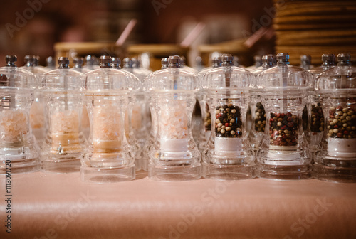 modern pepper and salt mills on display at a stylish eatery.