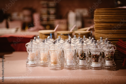 modern pepper and salt mills on display at a stylish eatery. photo