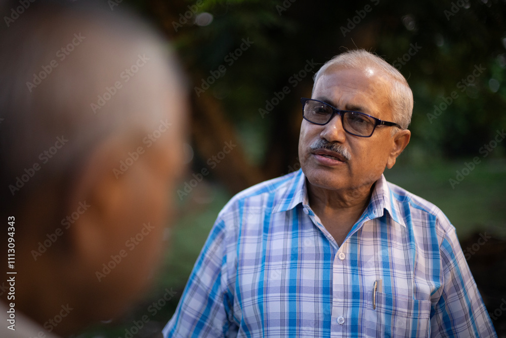 Two aged persons are speaking and making interactions Two aged persons are speaking and making interactions
