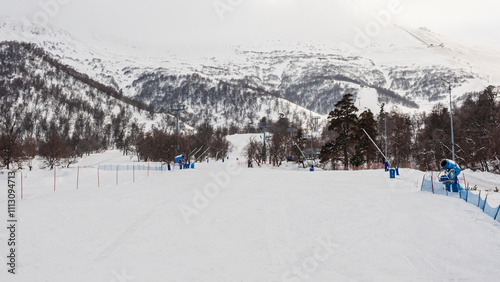 Snowy ski slope in the mountains during winter activities photo