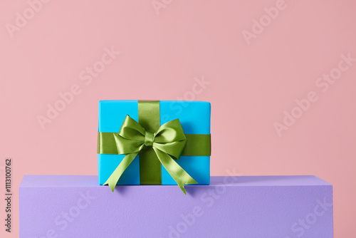 handmade present box on pink background with colors podium