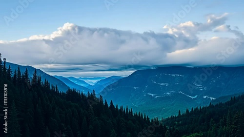 Lush Forests Sloping to a Valley with Blue Mountains and Clouds