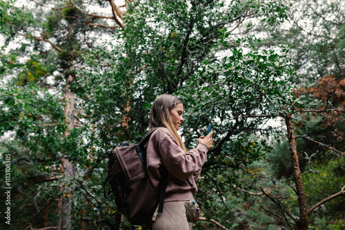 Expert hiker using the GPS of a cell phone to locate herself photo