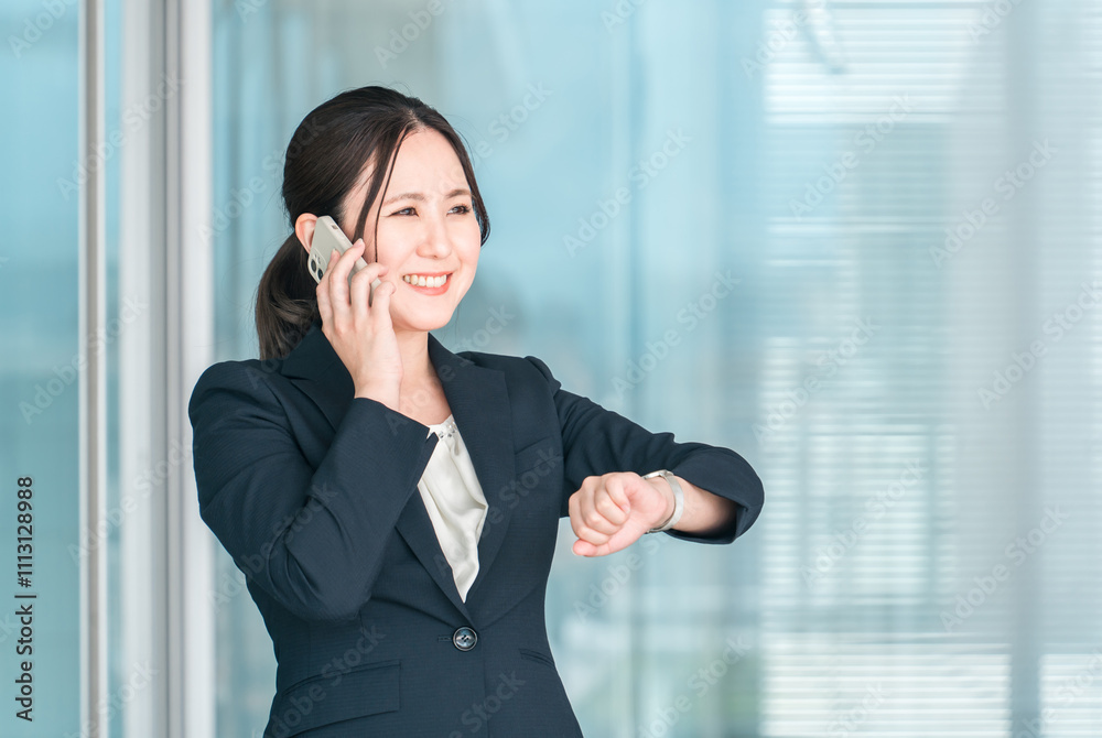 スマホで通話する笑顔の若いアジア人ビジネスウーマン
スマホで通話する笑顔の若いアジア人ビジネスウーマン