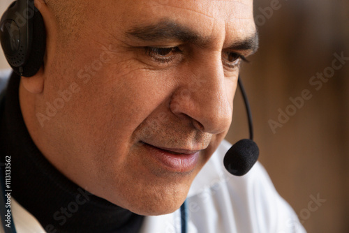 Doctor wearing headset listening during online medical consultation