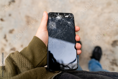 Broken Smartphone Screen in Hand