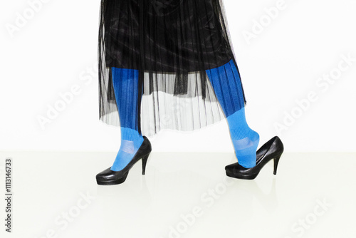 Person with high classic heels, blue tights and elegant mesh skirt  photo