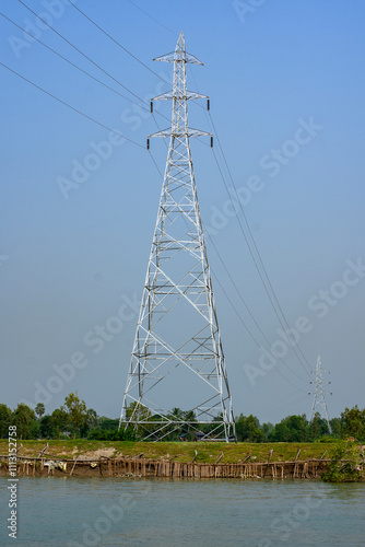 Electric Power Distribution Tower by a River in Rural India