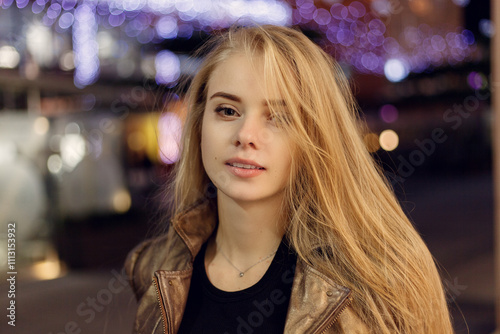 woman smiling in the night against evening lights bokeh