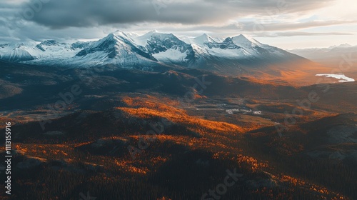 A stunning mountain landscape at sunset, showcasing snow-capped peaks and vibrant autumn foliage.