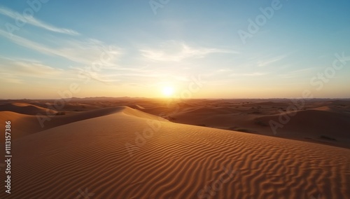 Serene sunset over rolling sand dunes in a desert landscape.