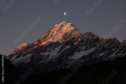 Snow Capped Mountain Peaks With Crescent Moon Rising photo