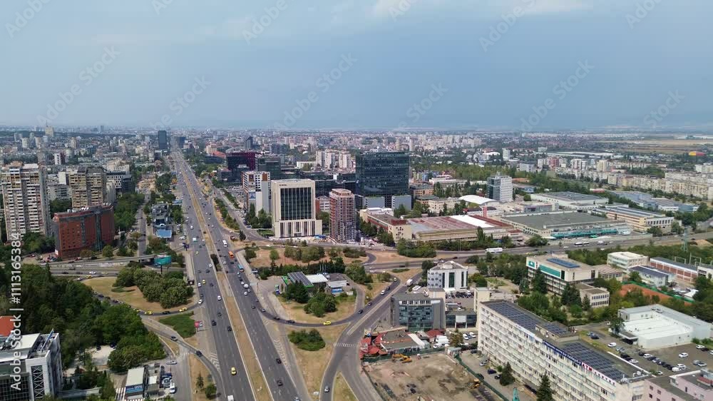 drone shot, rising above Sofia, the capital city of Bulgaria, on a rainy summer day with a with the traffic on Tsarigradsko shose blvd below