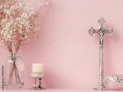 A silver cross on a pastel pink wall with a s photo