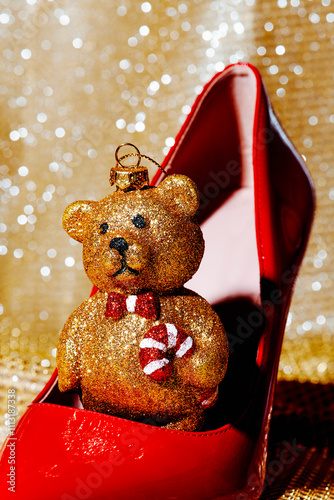 golden teddy bear in a red high-heeled shoe photo