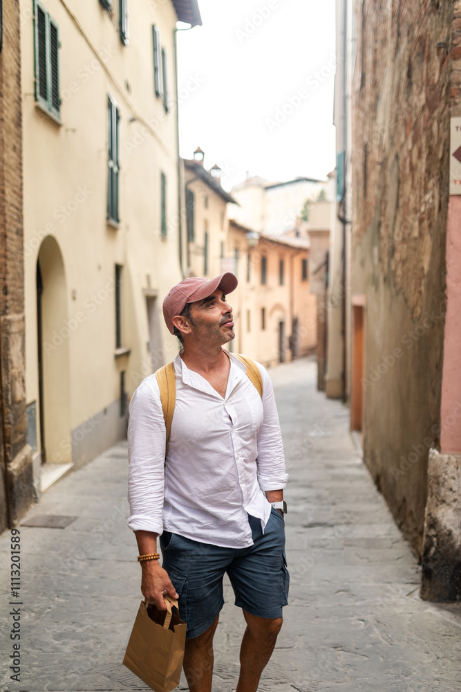 Tourist walking through the streets of a town in Tuscany in Italy. Tourist walking through the streets of a town in Tuscany in Italy.