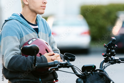 Teen holding crash helmet photo