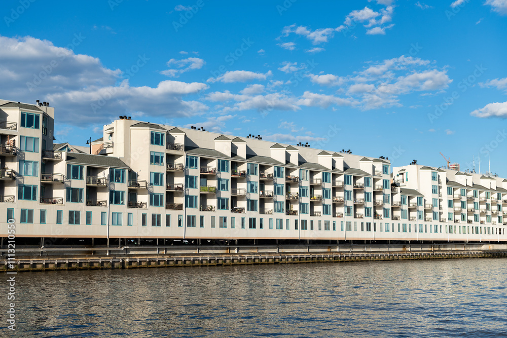 Fototapeta premium Residential waterfront apartment building. Waterfront architecture. Building with residential apartment at the river. Riva Pointe residential apartment building. modern architecture