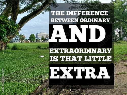 Motivational quote concept withthe difference between ordinary and extraordinary is a little extra blurred background  photo