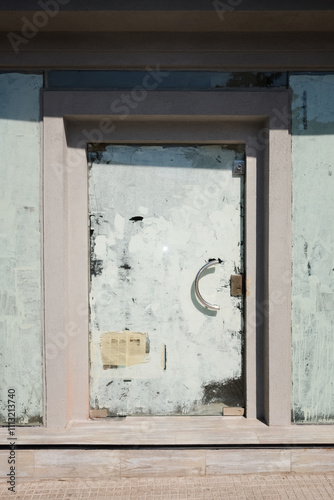 A boarded-up door on a building in a city photo