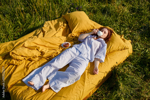 Relaxing on a warm summer day in a field with tea and pastry photo