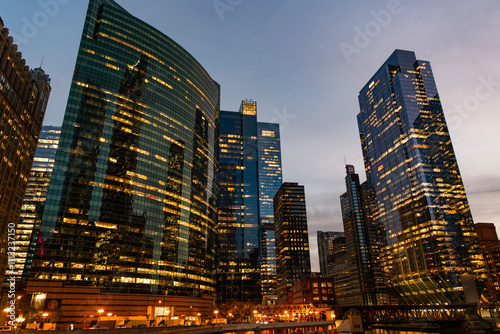 Business city. Night cityscape of Chicago skyscraper building. Chicago architecture of skyscraper. City night illuminated building. Skyscraper cityscape. Night city of Chicago. Riverwalk strolls