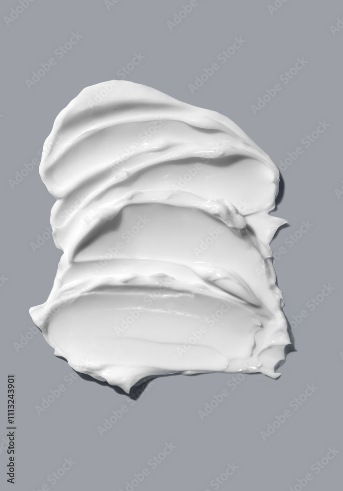 Swatch of moisturizing face, body cream on plain gray background. Swatch of moisturizing face, body cream on plain gray background.